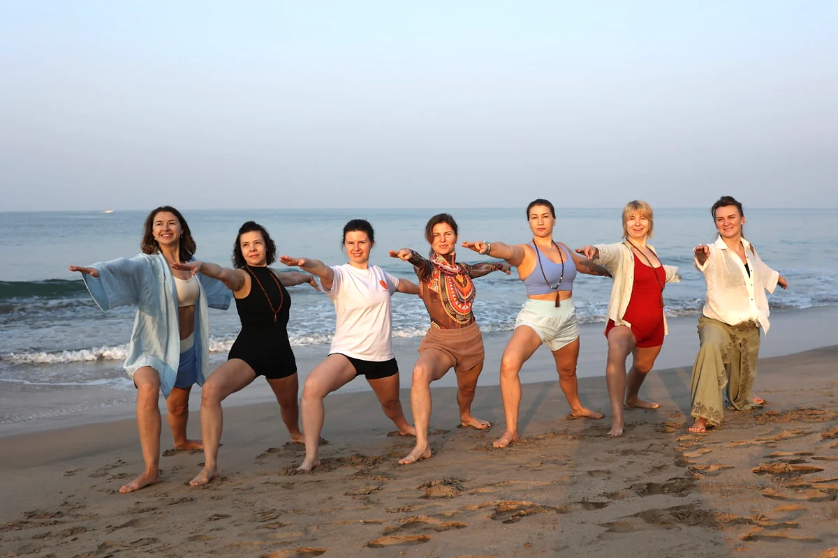 Purnam Yogashala students practising yoga together on Agonda Beach, Goa