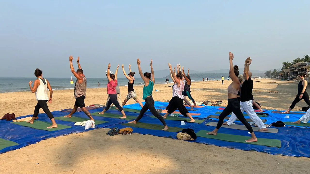 Yoga students practising together on Agonda Beach, South Goa